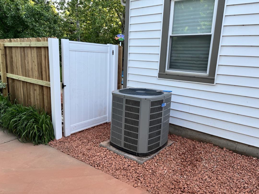 Newly installed AC condenser unit on a concrete pad at a home